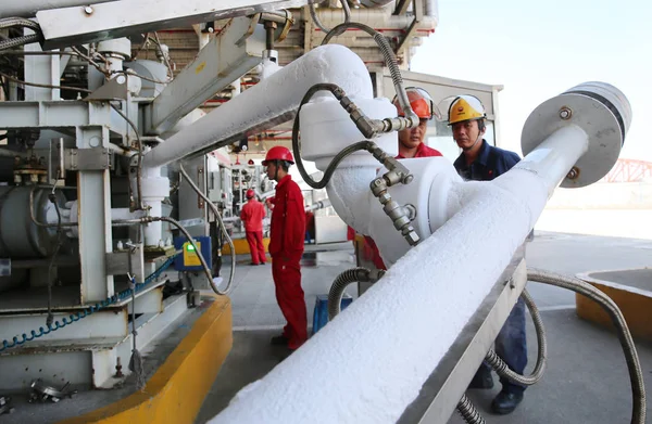 depositphotos_234321666-stock-photo-chinese-workers-load-tanker-liquefied