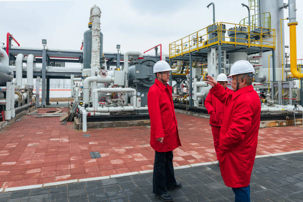 Engineers and staff communicate on site in chemical plant